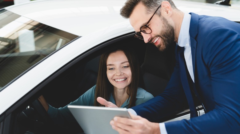 Man talking to woman in car