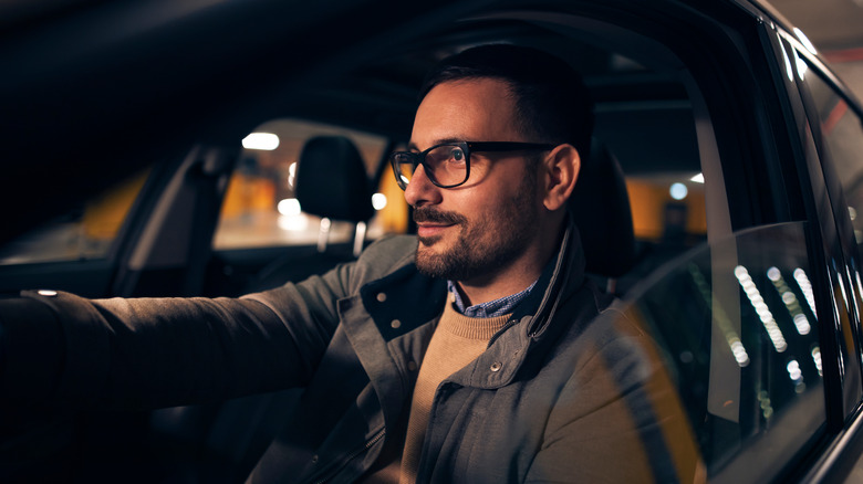 man driving at night