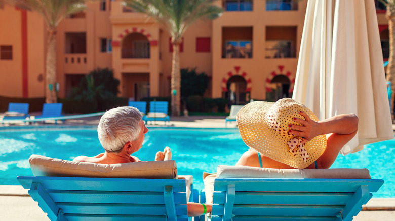 Couple lounging poolside