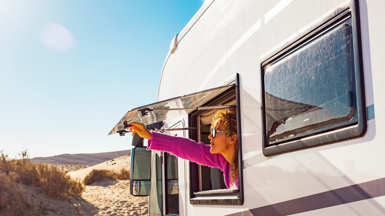 woman opening RV window