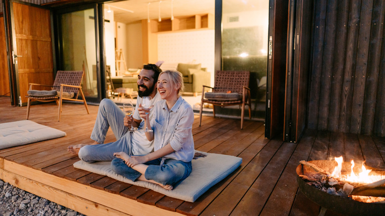 couple sitting by cabin 