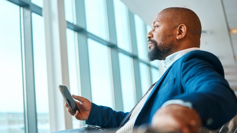 Airport passenger holding phone