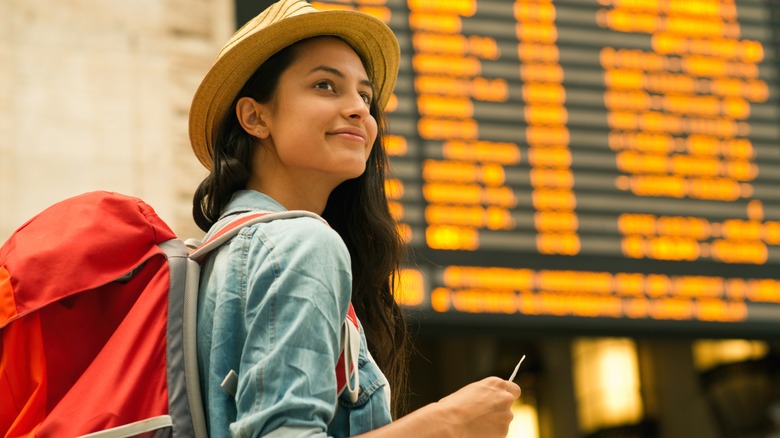 woman by airport flight board