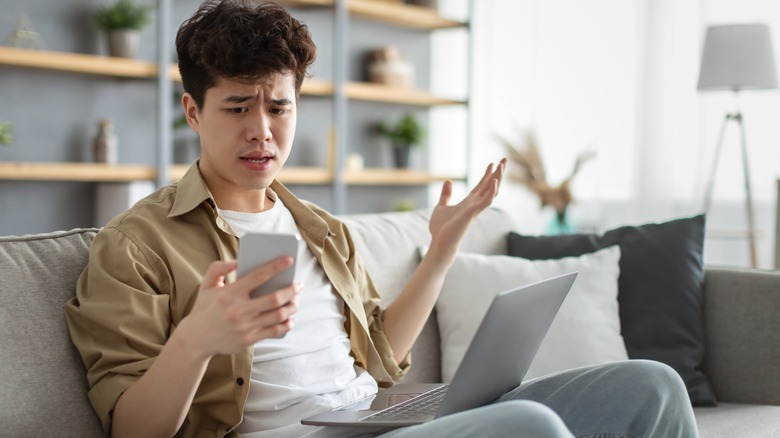 Confused man with laptop