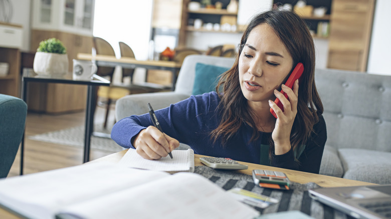 Person on phone taking notes