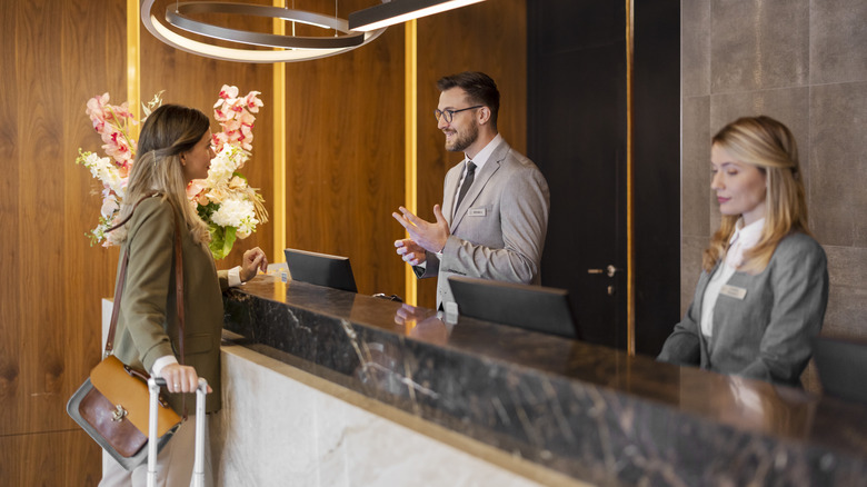 Woman checking in at luxury hotel