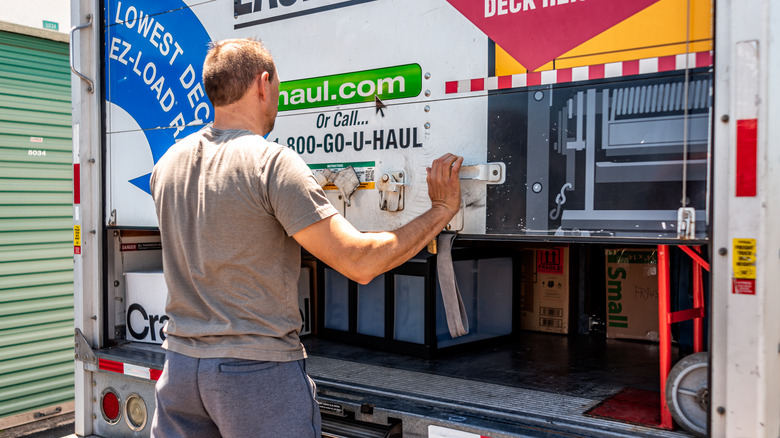 A person closing a U-Haul