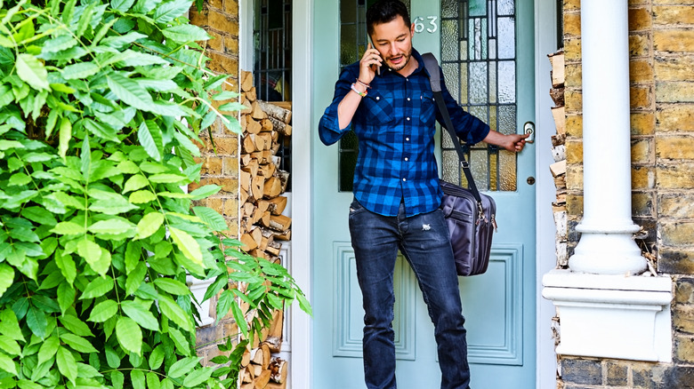 man in front of house