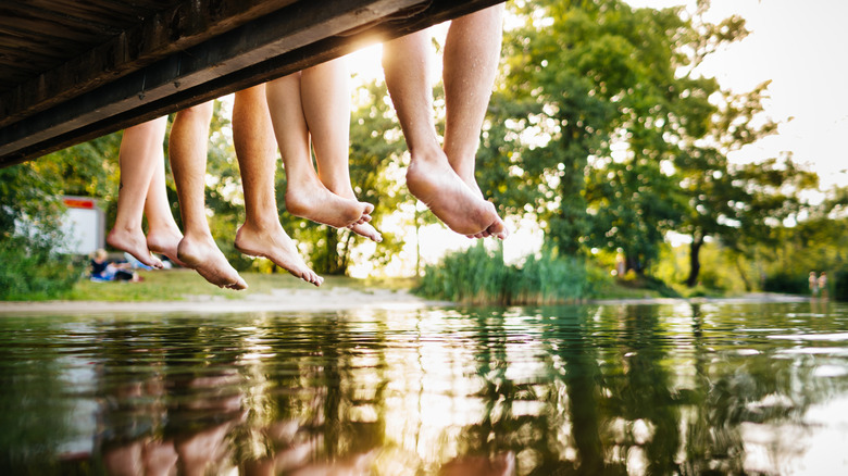 people relaxing on lakeside dock