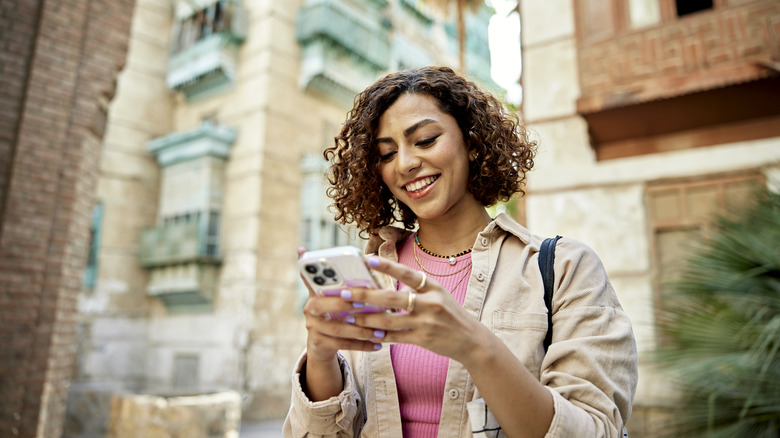 woman using iphone traveling