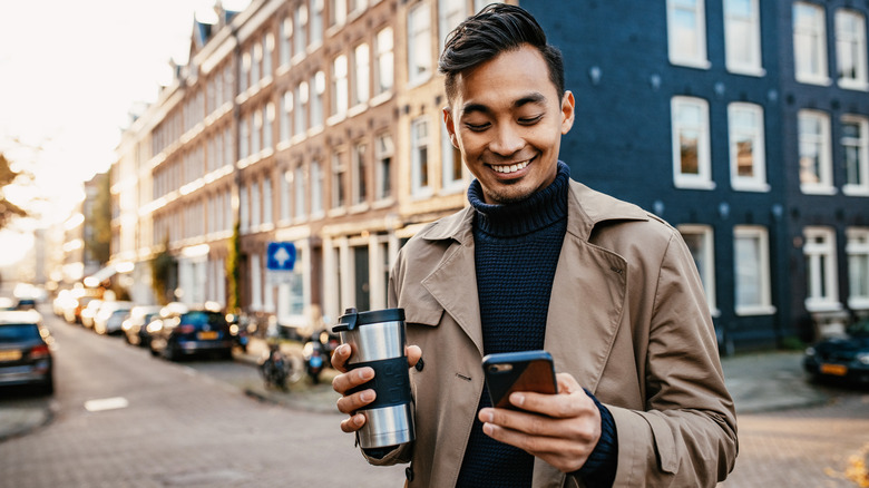 Man using phone traveling