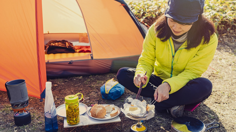 woman cooking at campsite