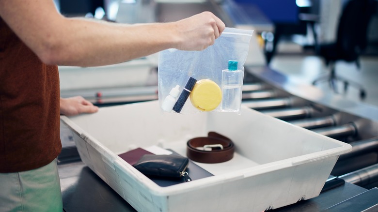 traveler with items in bag at airport security checkpoint