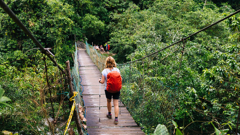 Woman crossing a bridge