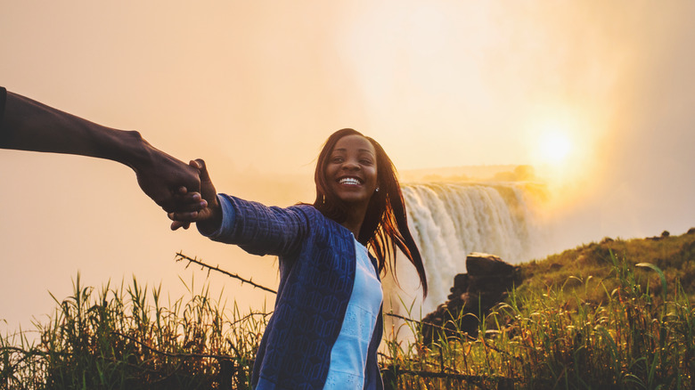 woman in front of Victoria Falls