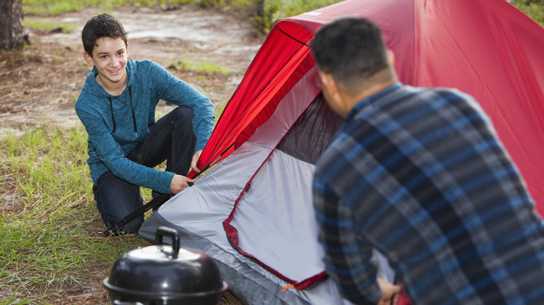 Man and boy with tent