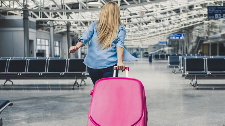 Person running with big suitcase