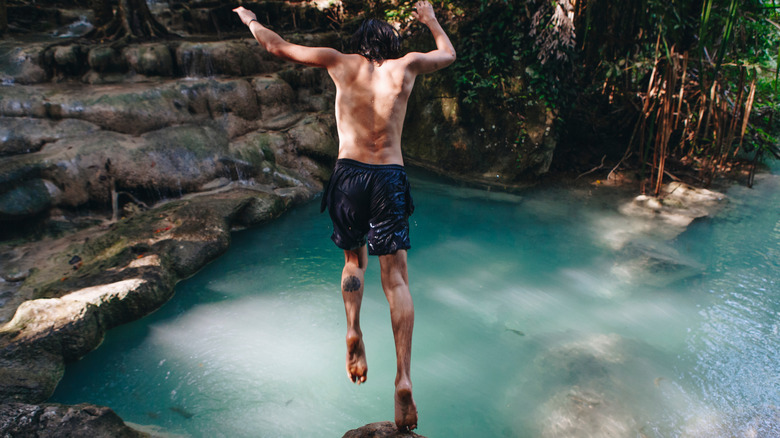 Person jumping into water