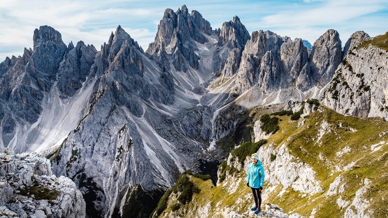 Hiker surrounded by jagged mountains