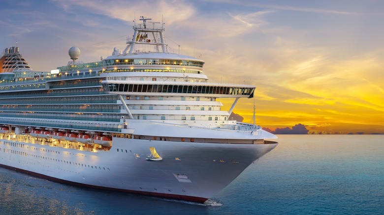 cruise ship sailing at sunset