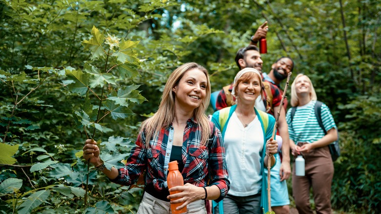 Five hikers smile in nature