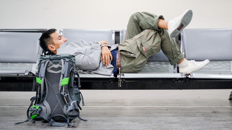 man sleeping in airport