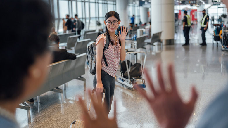 Family saying goodbye at airport