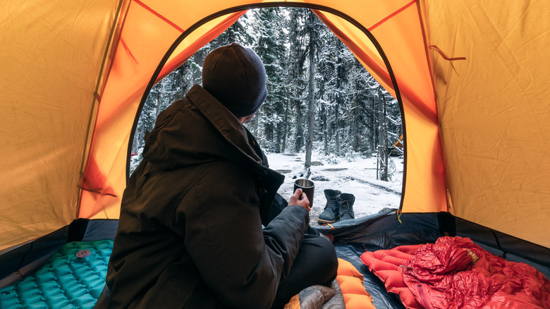 camper in tent during winter