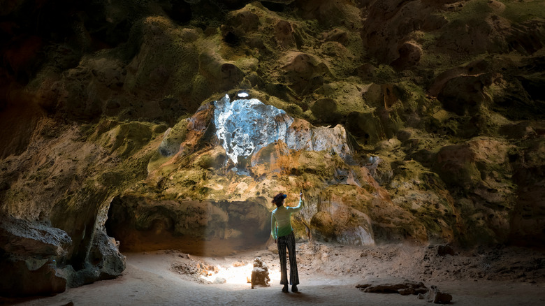 Woman standing in a cave at Arikok National Park, Aruba