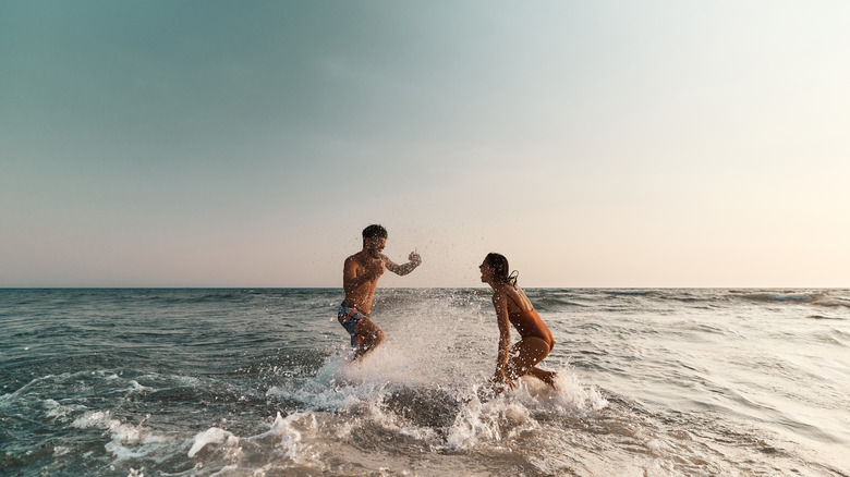 Couple frolics in surf