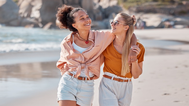 Women embracing on a beach