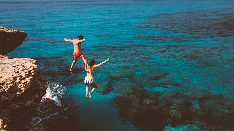 Two people diving into water