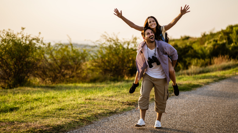 couple walking outside piggyback ride