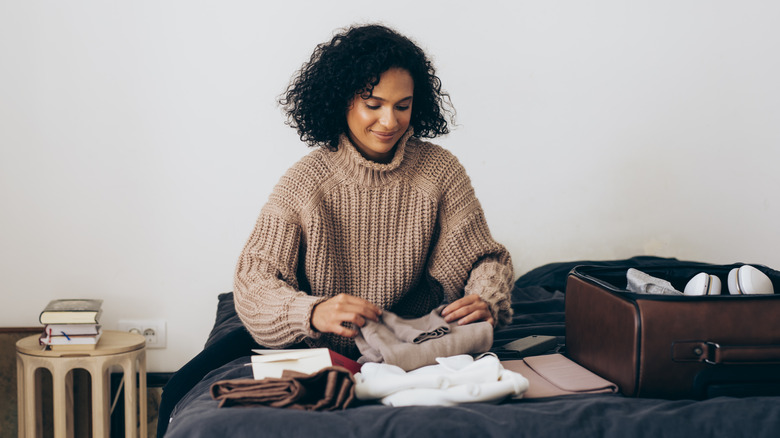 woman packing suitcase